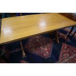 A light oak refectory style table on X-shaped end supports L.168cm