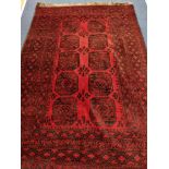 A Belouch red ground carpet 230 x 160cm