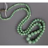 A single strand graduated jade bead necklace, with marcasite set sterling clasp, 68cm.