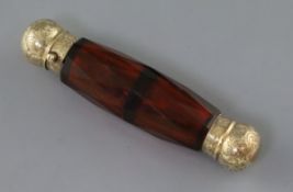 A Victorian engraved yellow metal mounted double ended facet cut ruby glass scent bottle, the