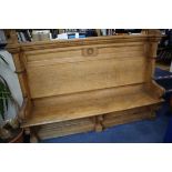 A late Victorian light oak hall seat W.220cm