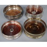 Four assorted modern silver wine coasters including one silver gilt.