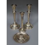A pair of silver candlesticks, a silver vase and a white metal midel of a hat.