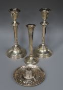 A pair of silver candlesticks, a silver vase and a white metal midel of a hat.