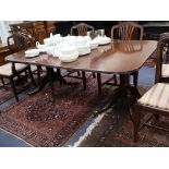 A Regency mahogany twin pedestal extending dining table, with one leaf W.173cm extended