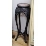 A Chinese carved hardwood urn stand with inset marble top H.90cm