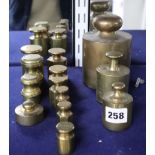 A collection of thirteen brass weights