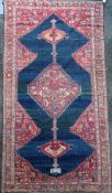 An antique Karabagh carpet, dated 1892, with stepped motifs on a red ground, with three row