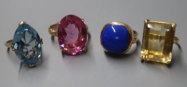 A 14K yellow metal and cabochon lapis lazuli dress ring and three other dress rings set with