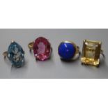 A 14K yellow metal and cabochon lapis lazuli dress ring and three other dress rings set with