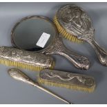 An Art Nouveau silver three piece dressing table set and Chinese white metal brush and buttonhook