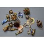 Four 14K gold charms, including a carousel and a collection of unmarked white and yellow metal