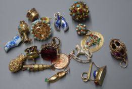 Four 14K gold charms, including a carousel and a collection of unmarked white and yellow metal