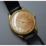 A gentleman's 750 yellow metal Lemania manual wind wrist watch, on associated black leather strap.