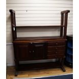 An oak 'cheese press' bookcase fitted cupboards and drawers W.150cm