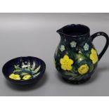 A Moorcroft buttercup style pattern baluster jug and a circular dish jug 15cm