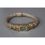 An Indian? white and yellow metal, coloured stone set bracelet.