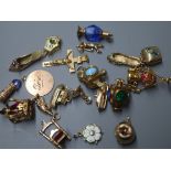 A 9ct gold crucifix pendant and a collection of nineteen 9ct gold charms, various, including a