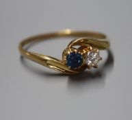 An 18ct gold, sapphire and diamond two stone crossover ring, size X.