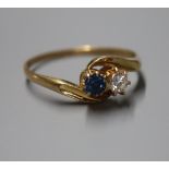 An 18ct gold, sapphire and diamond two stone crossover ring, size X.