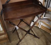 A Victorian mahogany bow fronted butler's tray on folding stand Tray W.74cm