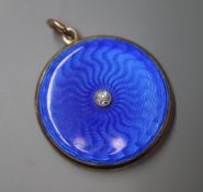 A Victorian yellow metal blue enamel and single stone diamond set circular locket, 29mm.