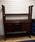 An oak 'cheese press' bookcase fitted cupboards and drawers W.150cm