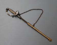 A yellow and white metal, enamel and seed pearl set jabot pin, modelled as a sword with scabbard,