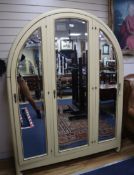 A French Art Deco painted arched three door wardrobe H.200cm