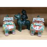 A pair of Chinese lion dog censers and covers and a pottery figure of a boy riding a qilin