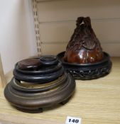 Various wooden and brass stands and a resin vessel