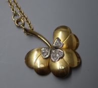 A modern 18ct gold and diamond set leaf pendant, on an 18ct gold chain, in Garrard & Co box, pendant