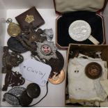 A collection of military buttons, badges, coins etc