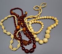 A simulated cherry amber bead necklace, an amber bead necklace and two ivory bead necklaces.