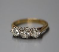 An 18ct and diamond three-stone ring, size L/M.