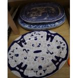 Two blue and white meat platters, a similar platter and a willow-patterned platter