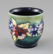 A Moorcroft 'orchid' small vase, 1930's, with a green to blue graduated ground, impressed W.