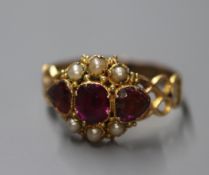 A Victorian 15ct gold, three stone garnet and seed pearl cluster ring, shank re-sized or