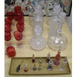 A collection of cranberry and decanters, etc.