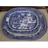 A graduated set of three blue and white Willow patterned meat platters