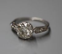 A mid 20th century white metal and single stone diamond ring, with diamond set shoulders, the old