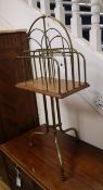 An early 20th century oak and tubular brass four division tripod newspaper stand W.37cm