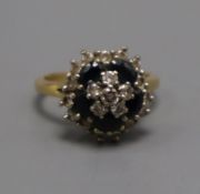 A yellow metal, sapphire and diamond cluster ring, size P.