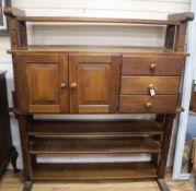 An oak 'cheese press' bookcase fitted cupboards and drawers W.148cm