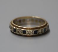 A 9ct yellow and white metal, two colour sapphire eternity ring, size L.