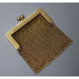 A small 14k yellow metal mesh purse.