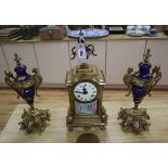 A gilt metal and porcelain mounted three piece clock garniture