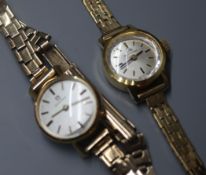 A ladys' Omega 9ct gold wristwatch and a similar Bucherer wristwatch, both with 9ct gold bracelets.