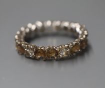 A white metal full eternity ring, now set with only three diamonds(a.f.), size M.