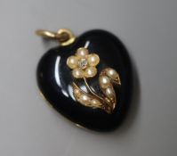 A Victorian yellow metal, black enamel, seed pearl and diamond set heart shape mourning locket, with